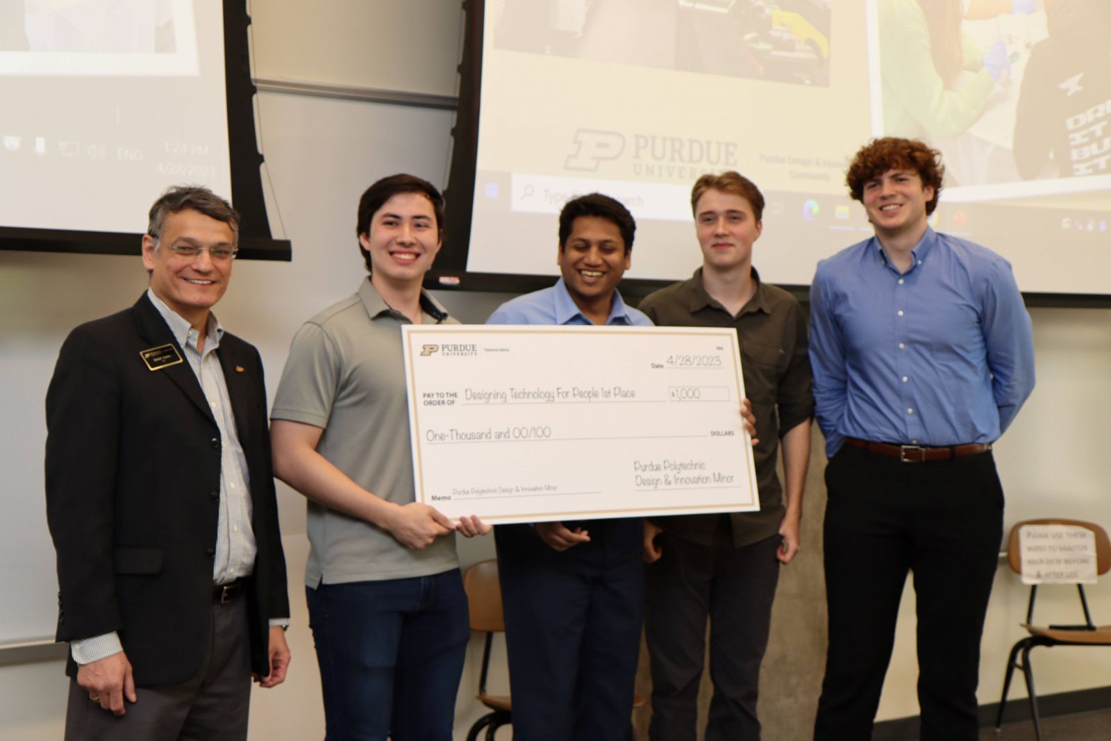The Helping Pilots team with Purdue Polytechnic Dean Daniel Castro-Lacouture at the Design and Innovation Challenge awards ceremony.