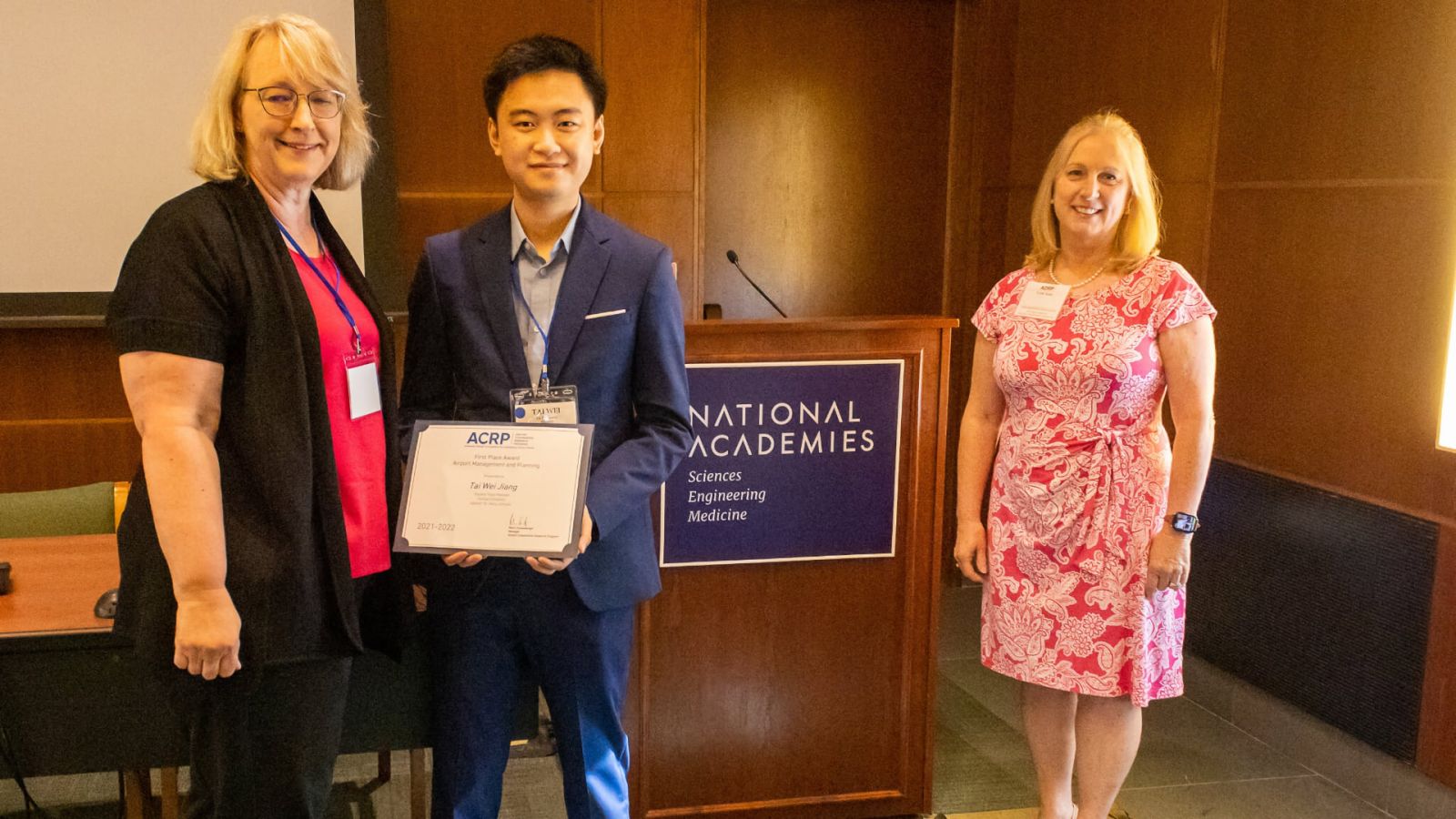 Mary Johnson (left) and Tai Wei Jiang (center) accept the first-place award for the Airport Management Planning Challenge area in the Airport Cooperative Research Program's University Design Challenge for Addressing Airport Needs from Trish Hiatt, deputy director of the FAA's Airport Safety and Standards Directorate at an award ceremony at the National Academy of Sciences Building in Washington, DC.  (Photo courtesy of the Virginia Space Grant Consortium)