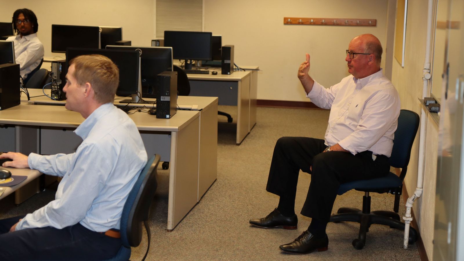 Tom Brew of Boilermakers Country consults with students and Professor James Tanoos (left).