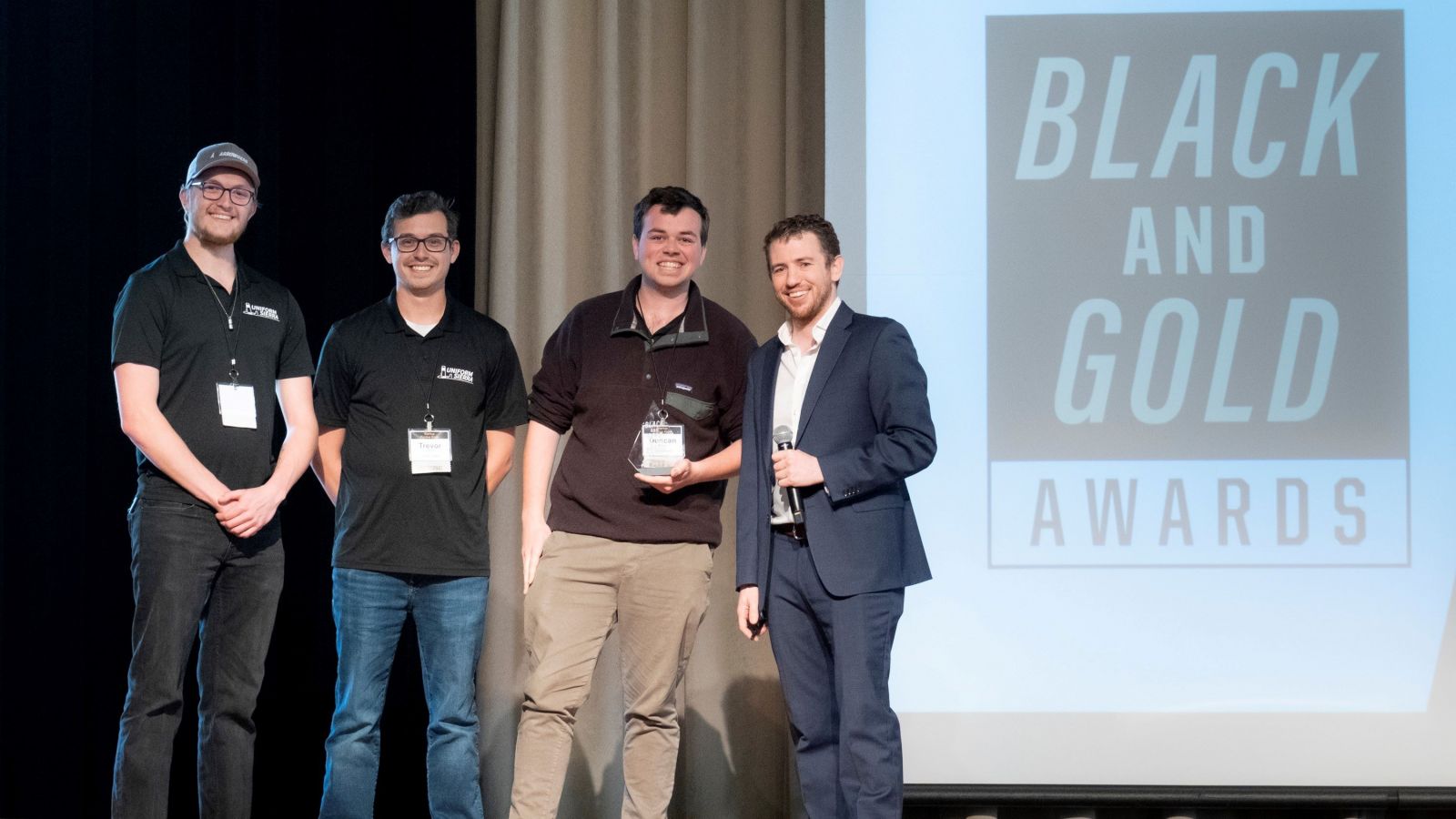 Uniform Sierra Aerospace participated in the biannual Black and Gold Awards pitch competition. Purdue Innovates Startup Foundry, led by Tyler Mantel (far right), awarded $100,000 to the company founded by Jeremy Fredrick (far left), Trevor Redpath (center left) and Duncan Mulgrew (center right). (Photo credit: Vincent Walter)