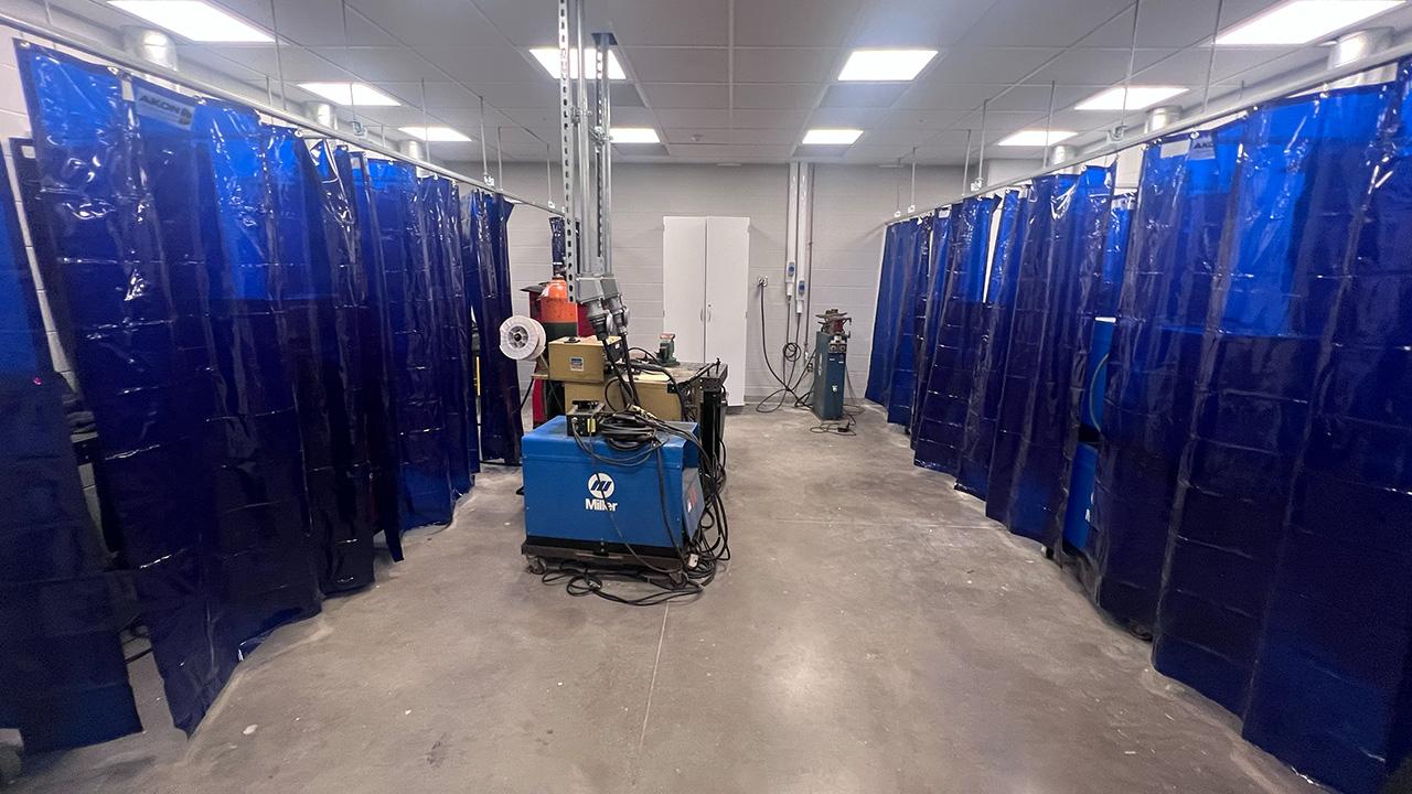 The School of Engineering Technology's Welding Lab, outfitted with blue welding curtains designed for UV light and spark protection.