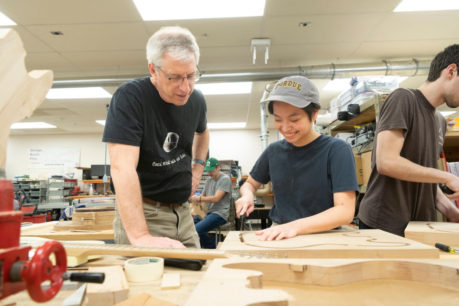 Professor Mark French works with a student on a guitar body in Purdue Polytechnic's sought-after "guitar lab"