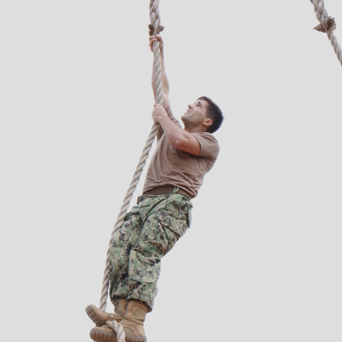 Midshipman Dominic Giacomin completes the rope climb at the end of the new ROTC obstacle course. (Purdue University photo/Nick Pompella)