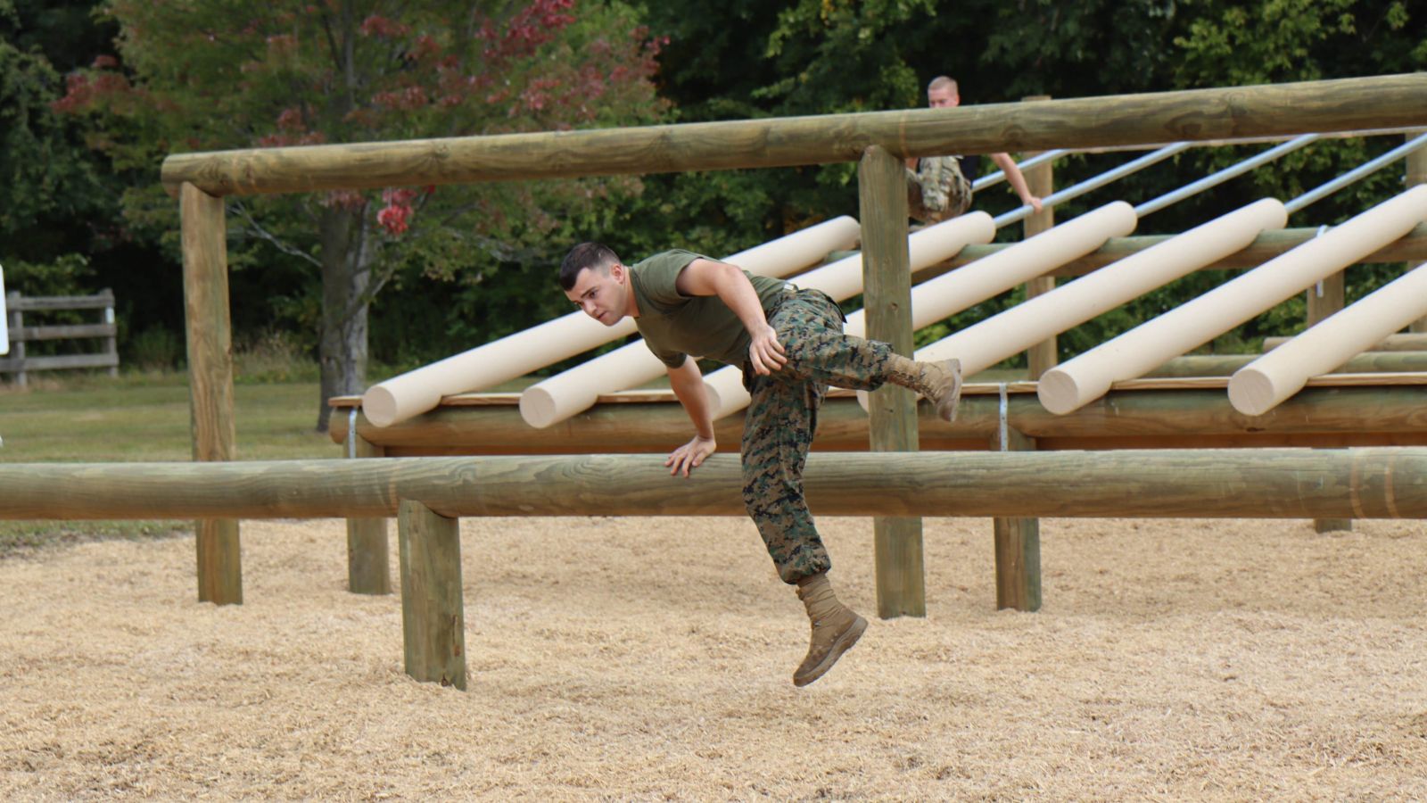 Commanding Officer Alexander Ozete vaults over an obstacle during a time trial. (Purdue University photo/Nick Pompella)