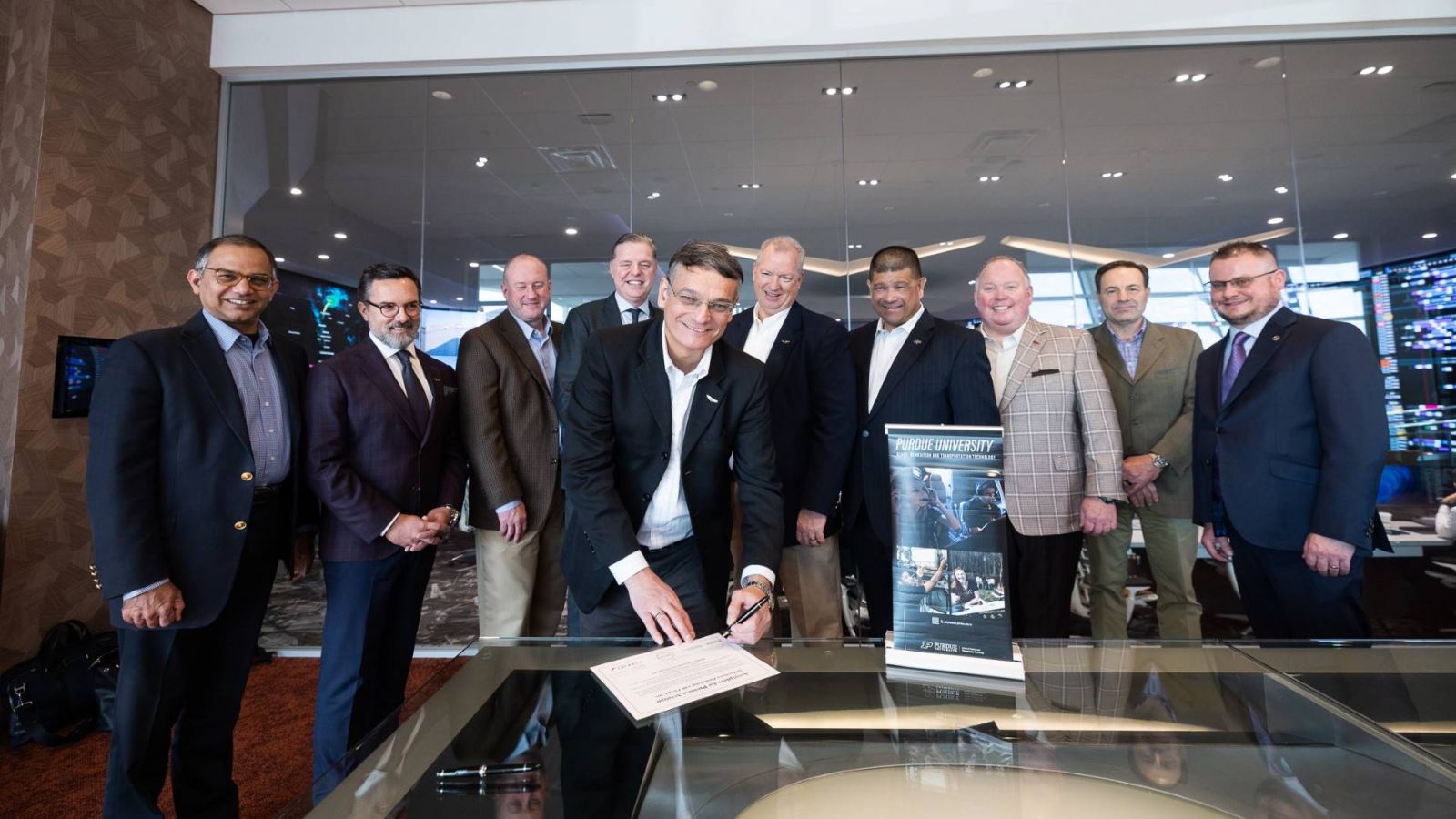 Purdue Polytechnic's Dean, Daniel Castro, inks the recent deal establishing the Aerosphere cooperative between Purdue's CREATE lab and Flexjet. (Photo provided: Flexjet)