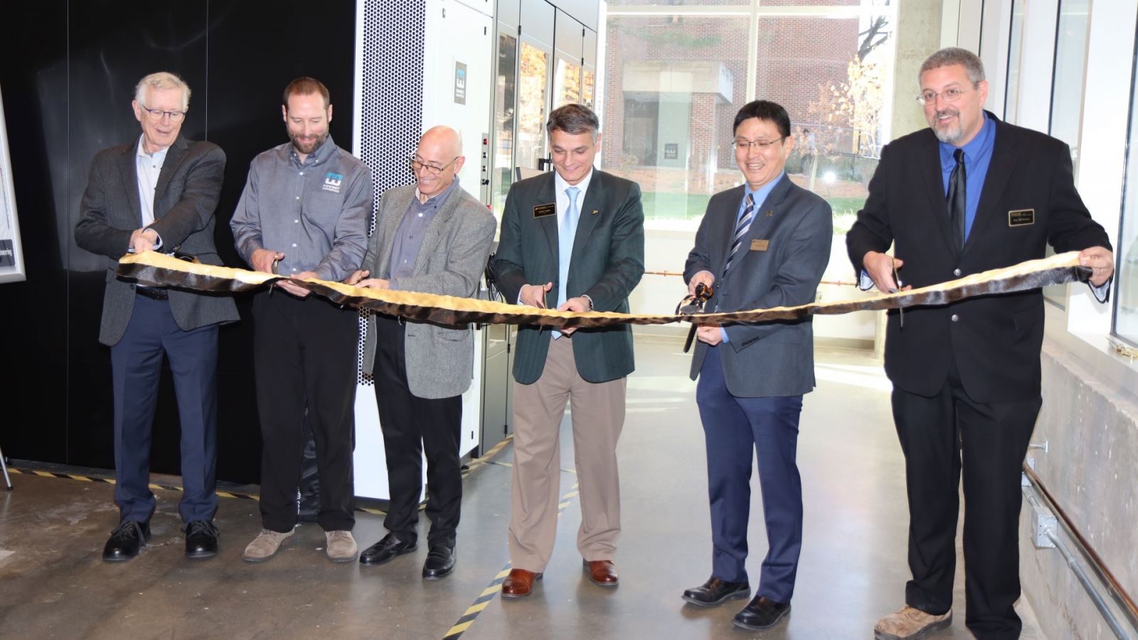 Representatives from Howmet and Zeiss joined Purdue for the ScanBox ribbon cutting. Purdue members, from left to right, include Ken Burbank, Daniel Castro, Young-Jun Son and Paul McPherson. (Purdue University photo/John O'Malley)