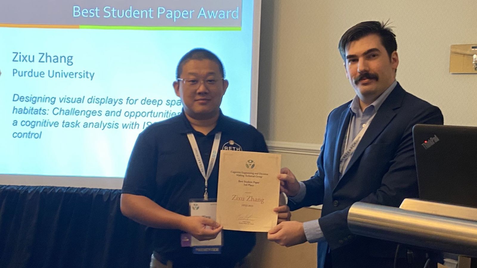 Zixu Zhang (left) earns his award at the 67th annual HFES meeting. (Photo provided)