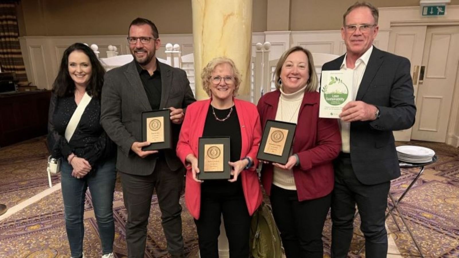 Chad Laux (second from left) won his latest book award in a recent series for "Lean Sustainability," released in November 2023. (Photo provided)