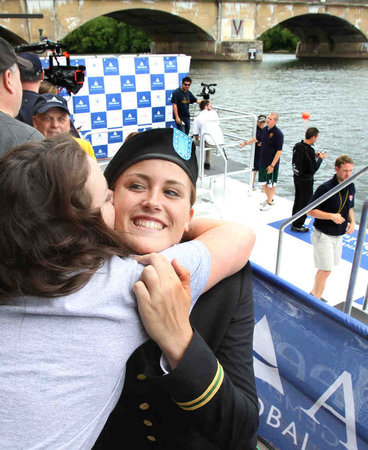 Purdue rower Rachel Young , moments before her waterfront commissioning as an officer in the Army, gets a hug from her sister Hannah.