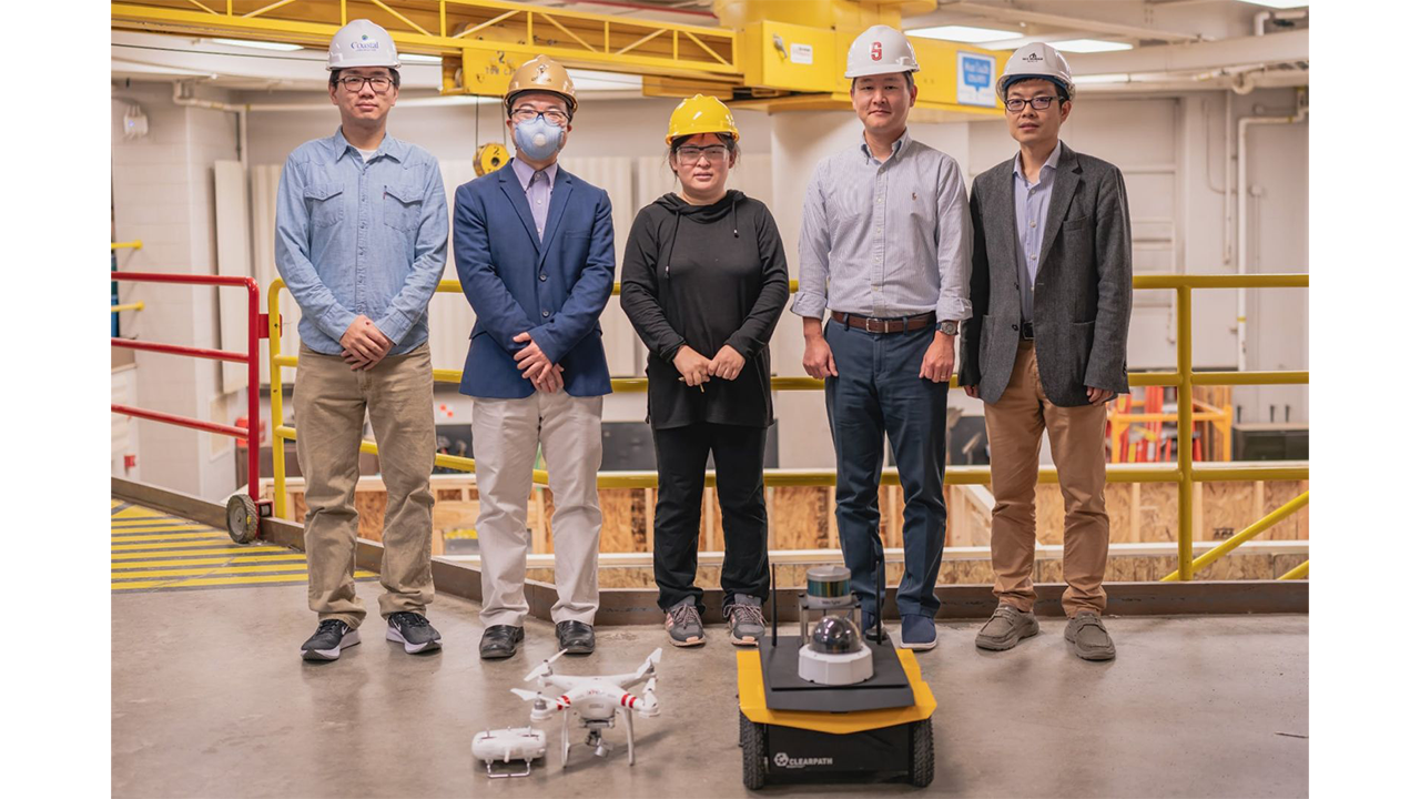 Yifu Wu (graduate research assistant), Jiansong Zhang (co-principal investigator), Jin Wei-Kocsis (principal investigator), Byung-Cheol “B.C.” Min and Dongming Gan (co-principal investigators), standing in Knoy Hall’s D. Dorsey Moss Construction Lab with an unmanned aerial vehicle and a robotic vehicle