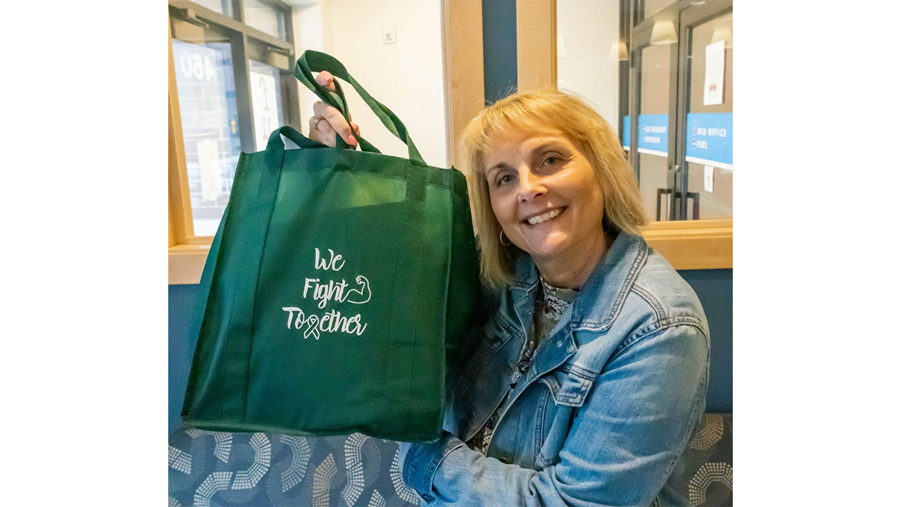Julie LaGrange holds up a We Fight Together care package (Purdue University photo/Alison Manges)