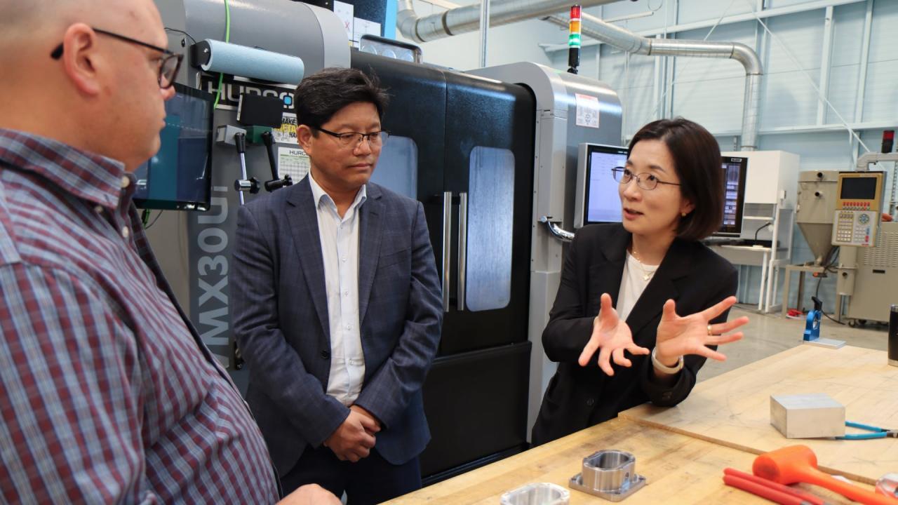 Noori Kim (right) discusses research opportunities with Nathan Hartman (left) and Seung Ki Moon, an associate professor and assistant chair for research at Nanyang Technological University (Singapore), during a meeting at IN-MaC. (Purdue University photo/John O'Malley)