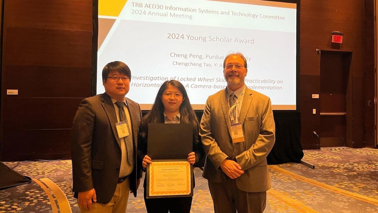 Cheng Peng (center) receives TRB's Young Scholar Award at their 2024 Annual Meeting.
