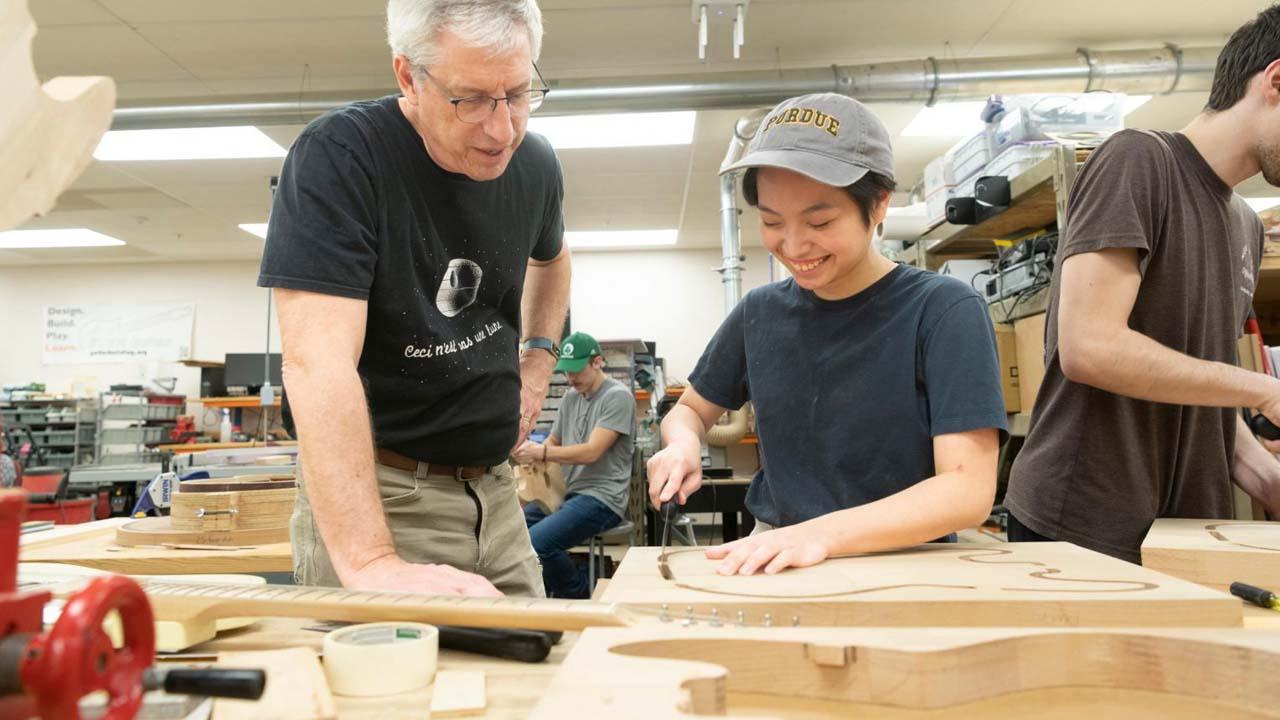 Professor Mark French works with a student on a guitar body in Purdue Polytechnic's sought-after "guitar lab"