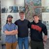 Pictured: Three of the five students involved in the capstone project in front of Berlin Wall fragments. This particular project saw the team collaborate with a university in Bocholt, Germany. (Purdue University photo/Robert Weissbach)