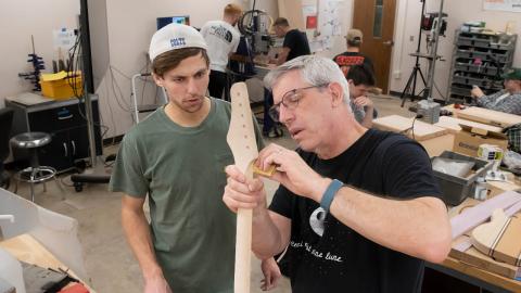 Mark French, professor of mechanical engineering technology, with a student in the popular "guitar lab" course (Purdue University photo/John Underwood)