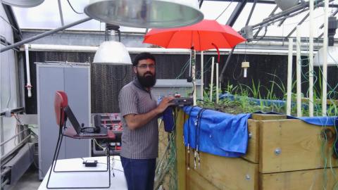 Abdul Salam takes measurements in a test bed at Purdue University to determine the optimum operating frequency for underground antennas.