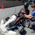 A student driver prepares to test his team's electric go-kart.
