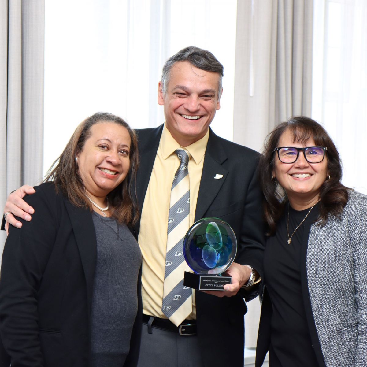 Cathy Pullings (left), the winner of multiple staff awards, is pictured along with Polytechnic's dean and Antonia Munguia, director of the recruitment, retention and diversity office. (Purdue University photo/John O'Malley)