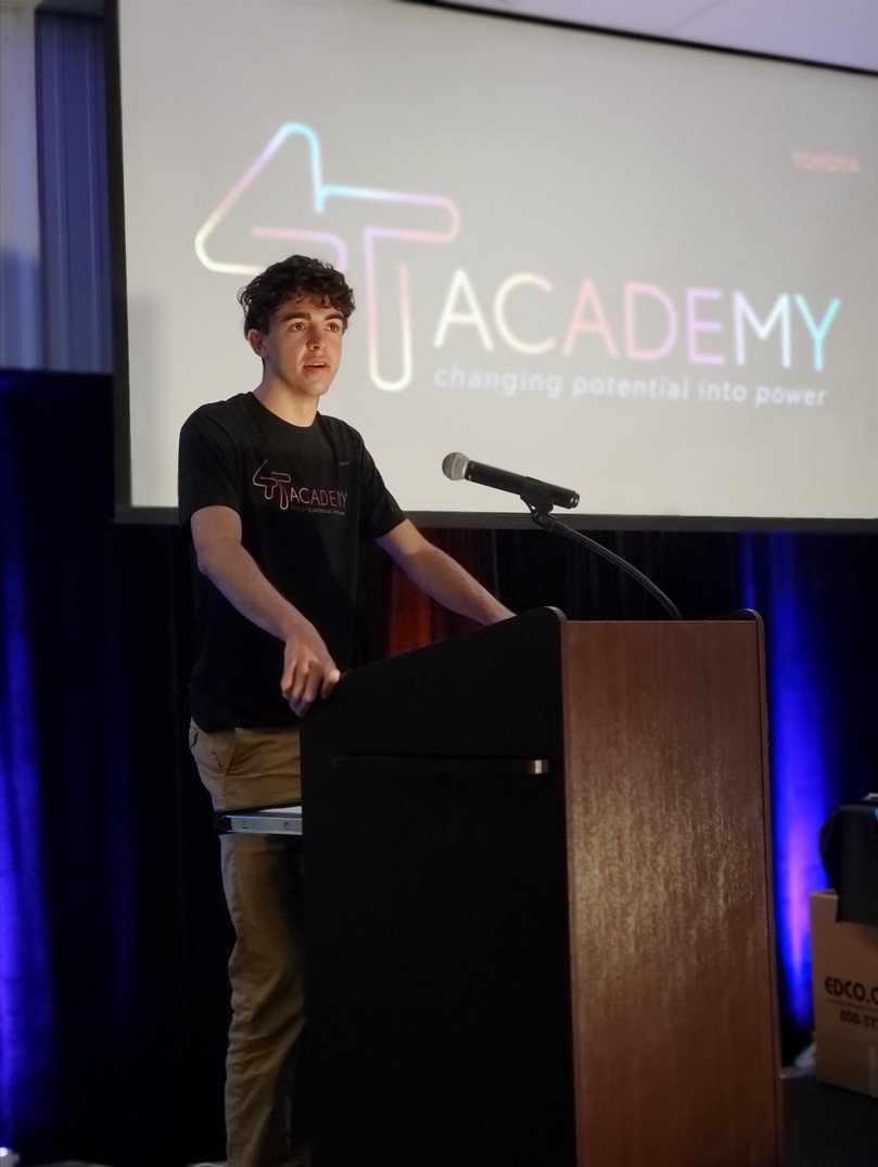A 4T Academy graduate present to an audience at the Toyota Motor Manufacturing West Virginia headquarters.