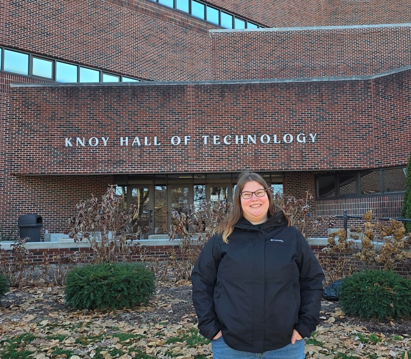 Sarah Van Sickle stands on Purdue University's West Lafayette campus in front of the KNOY Hall of Technology